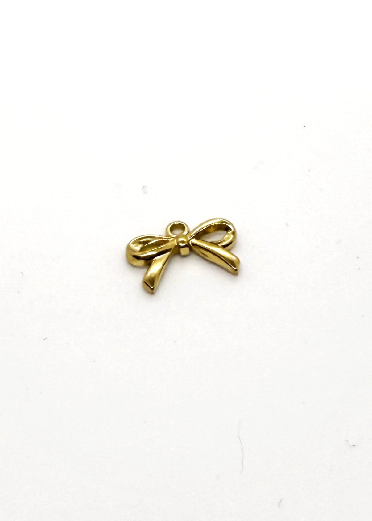Gold Stainless steel bow-shaped pendant on a white background