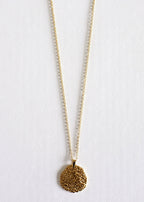 A gold stainless steel crater pendant on a chain, displayed on a white background.