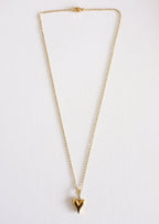 A gold-colored stainless steel necklace with a heart-shaped pendant, displayed on a white background.
