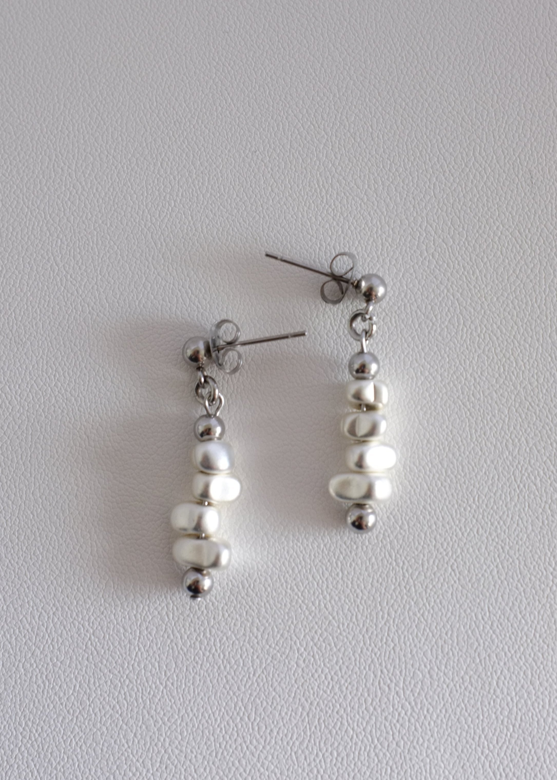 A pair of silver drop earrings with hematite beads, displayed against a white background.