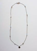 A silver-colored stainless steel chain necklace with multicolor bicone glass beads and a round engravable pendant.