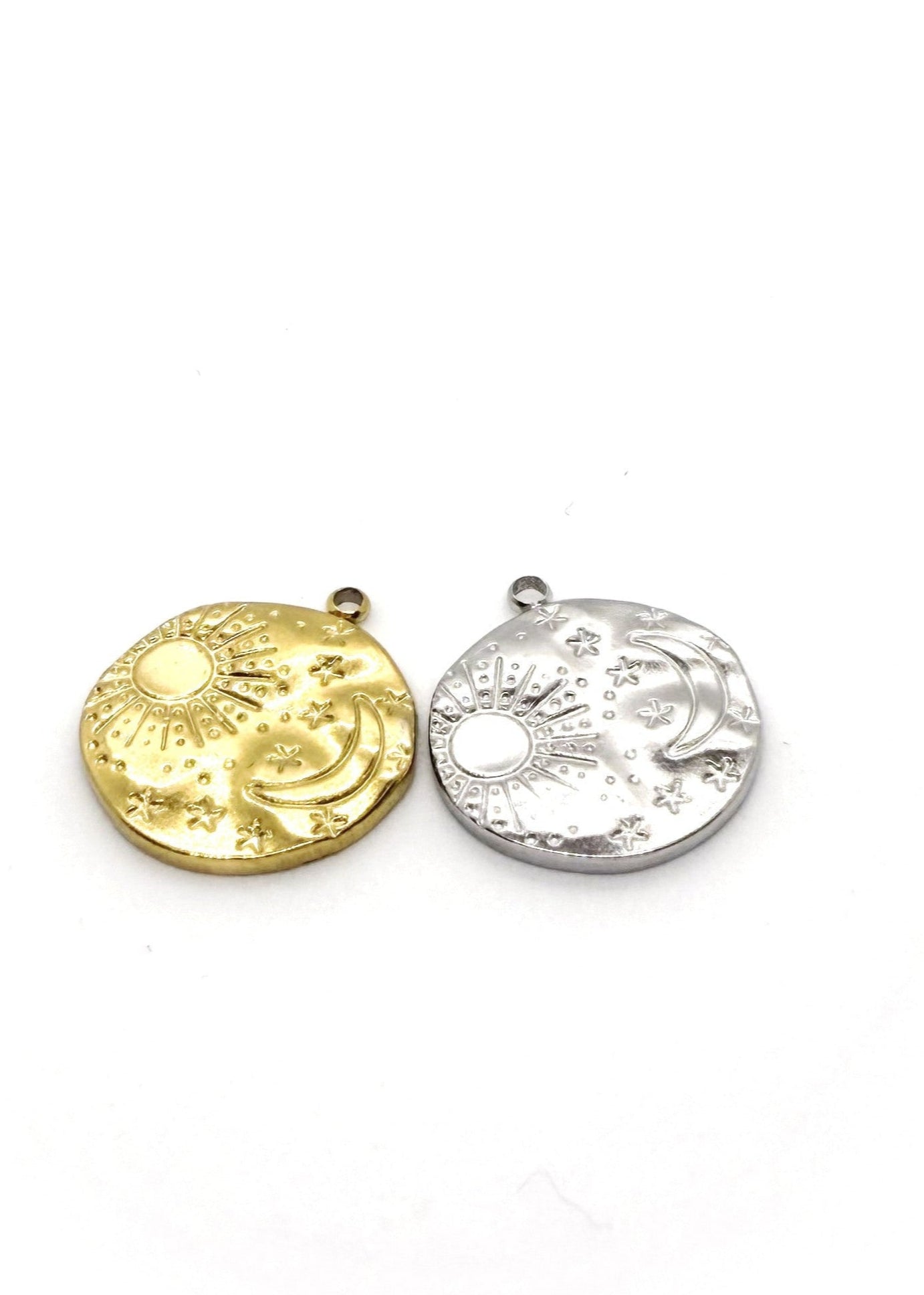 Gold and silver stainless steel circular charms  on a white background