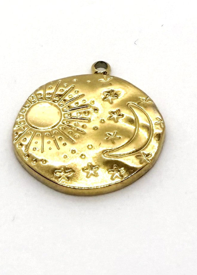 Gold stainless steel charm with sun, moon, and star designs on a white background