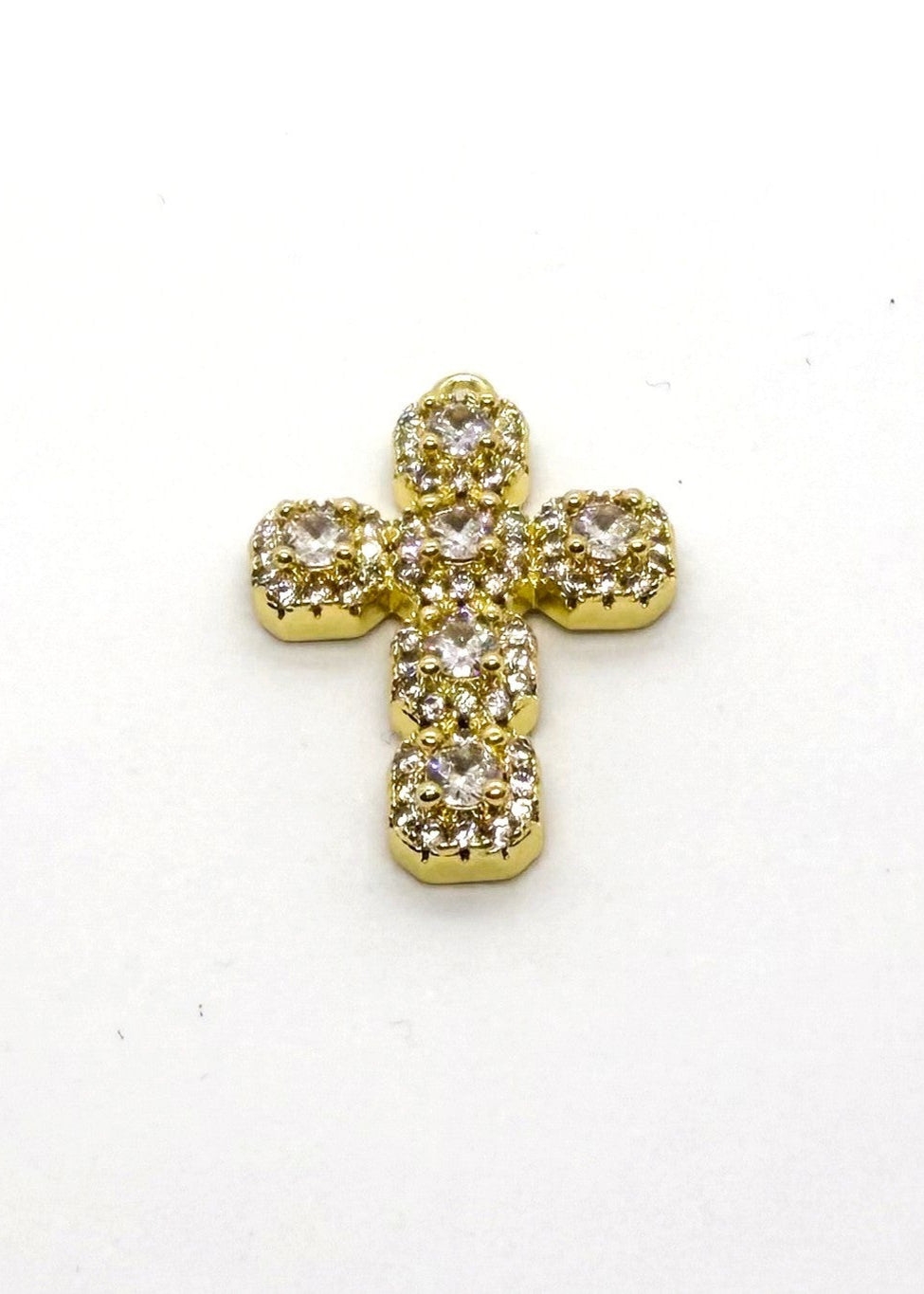 Gold stainless steel cross with embedded zirconia on a white background