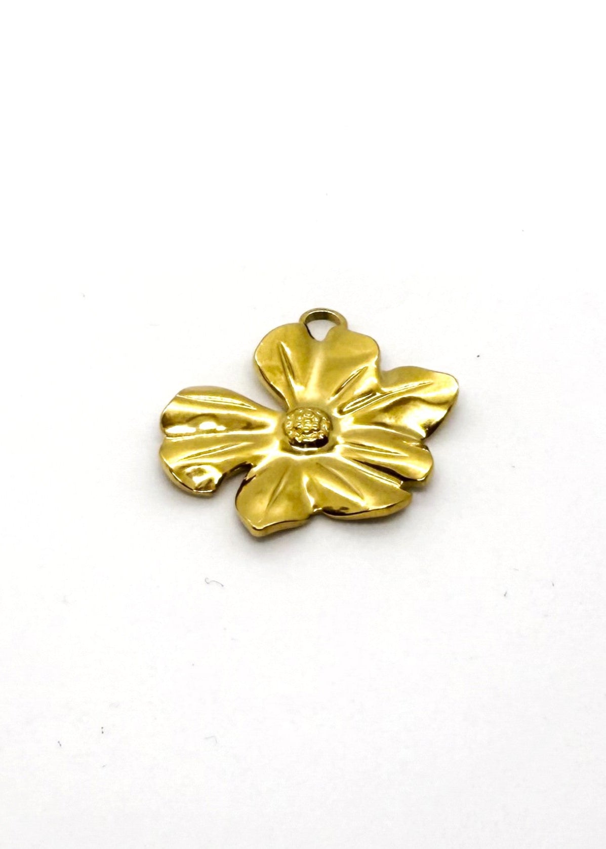 Gold stainless steel flower-shaped charm on a white background