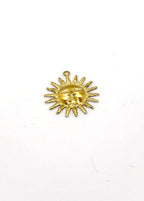 Gold sun-shaped charm on a white background