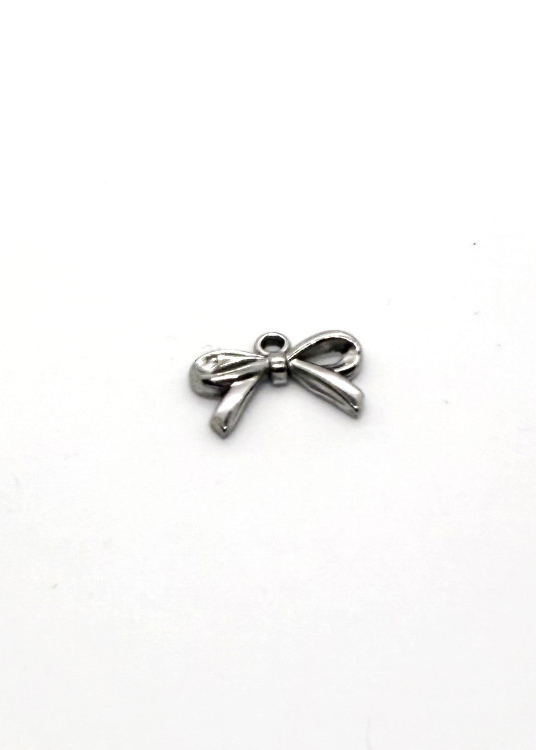 Silver Stainless steel bow-shaped charm on a white background