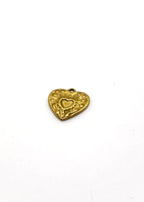 Gold heart-shaped charm on a white background