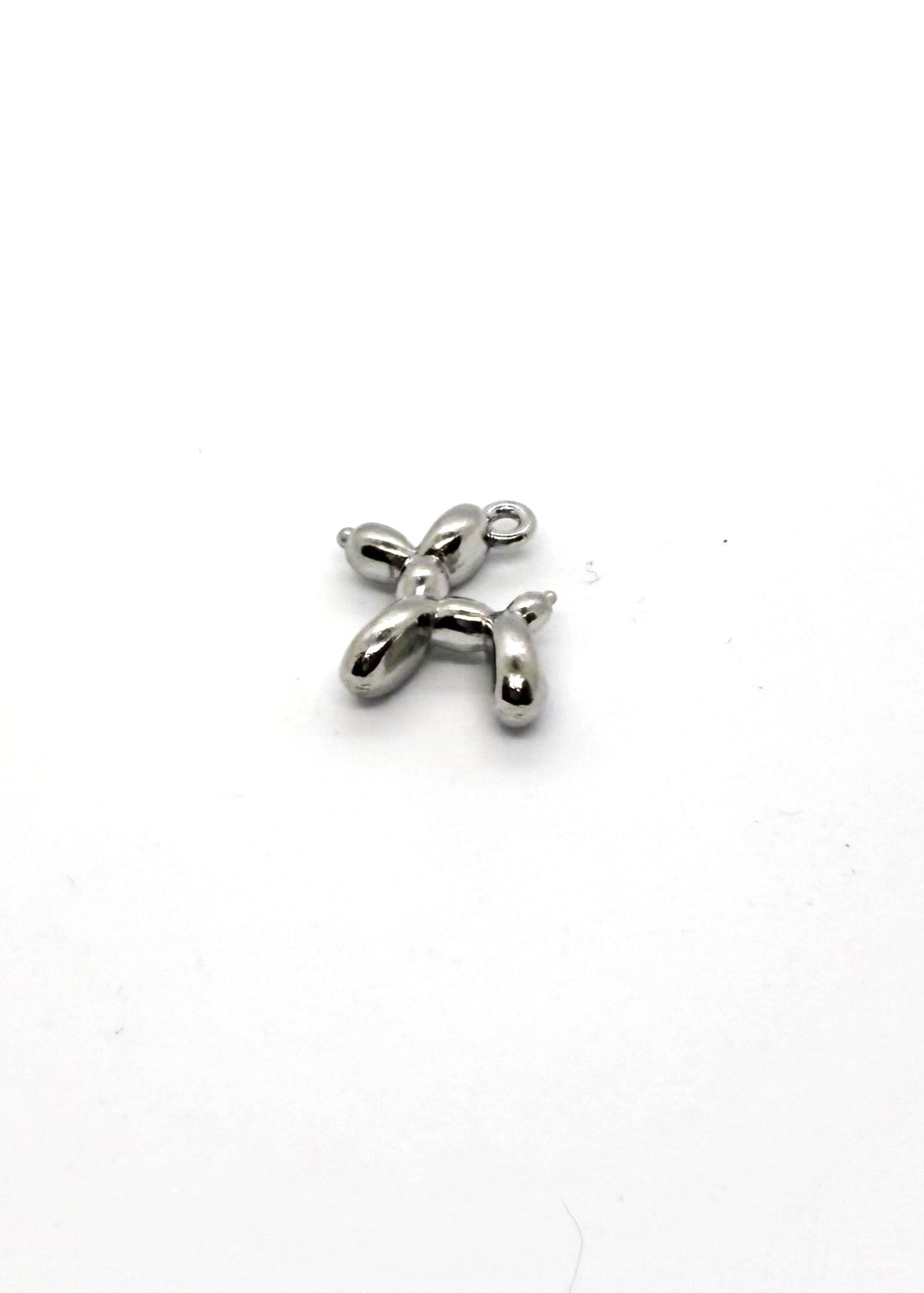 Silver balloon dog charm on a white background