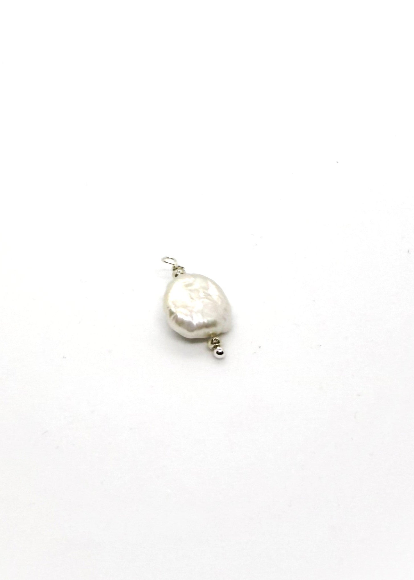 Natural freshwater pearl charm on white background