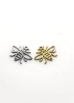 Two stainless steel bee-shaped charms, one gold and one silver, on a white background.