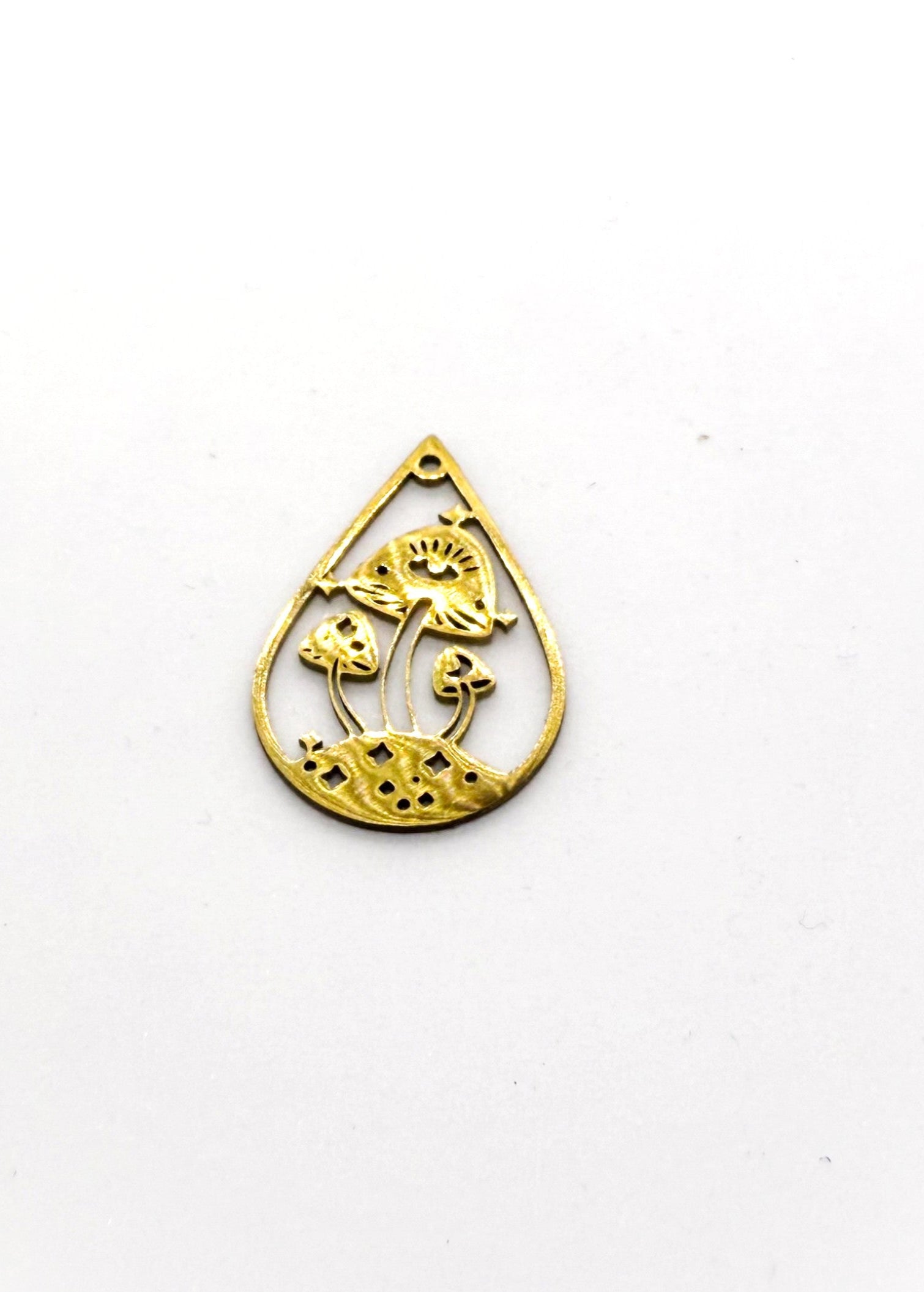 Gold stainless steel teardrop-shaped charm with intricate designs on a white background