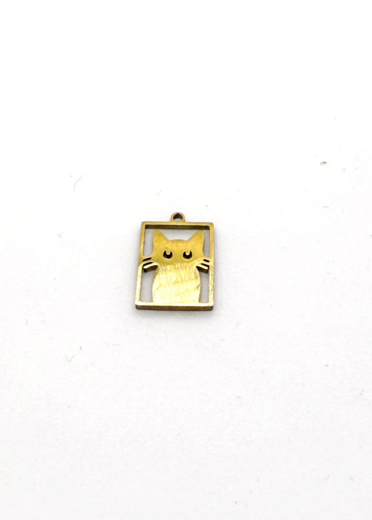 Gold stainless steel cat-shaped charm on a white background