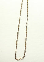 Gold stainless steel chain necklace on a white background