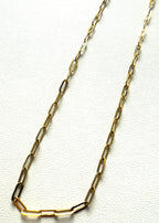Gold stainless steel chain necklace on a white background
