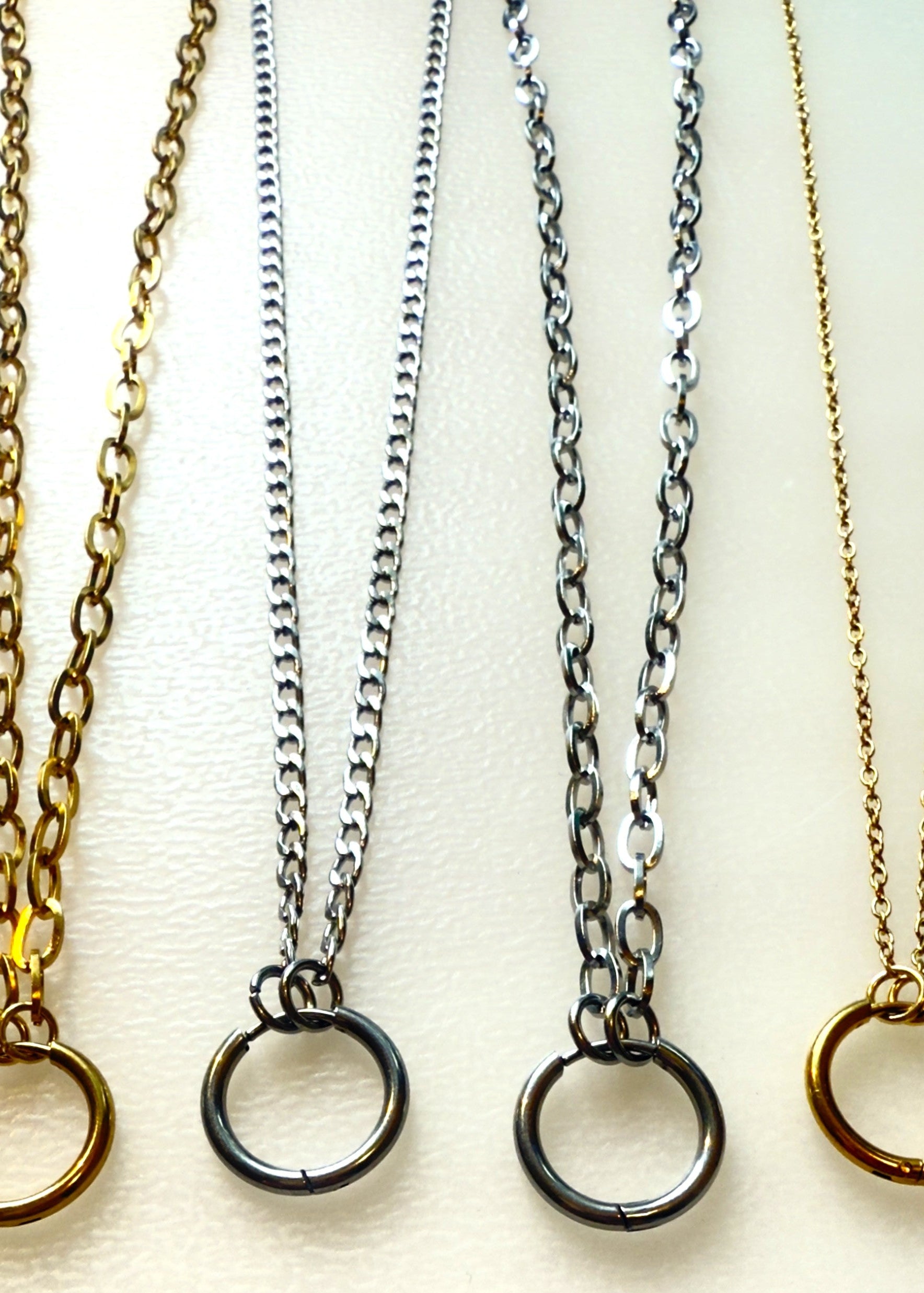multiple chain on a white background with a ring charm holder